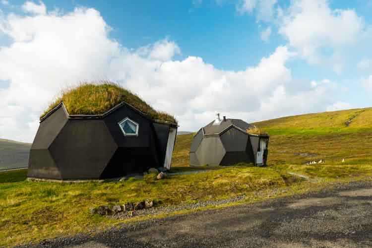 Kvivik (Kvívík) Streymoy Faroe Islands, Denmark, Europe; September 2019: Weird houses - two tiny geometric igloo homes with grass roofs on the hills. Most original houses and eco friendly in the world